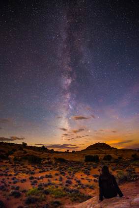 Girl Sitting on the rock looking at the Milky Way
