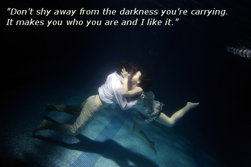 Kissing pair on bottom of swimming pool