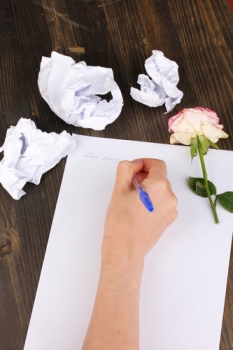 Creation of composition and crumpled sheets on wooden table