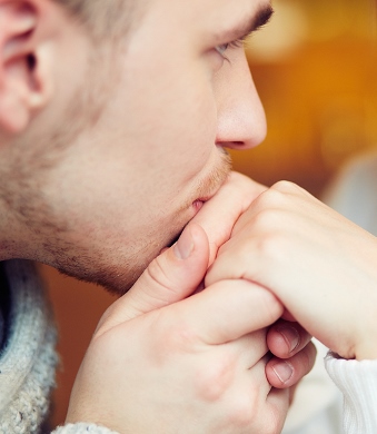 Guy kissing hand of his girlfriend